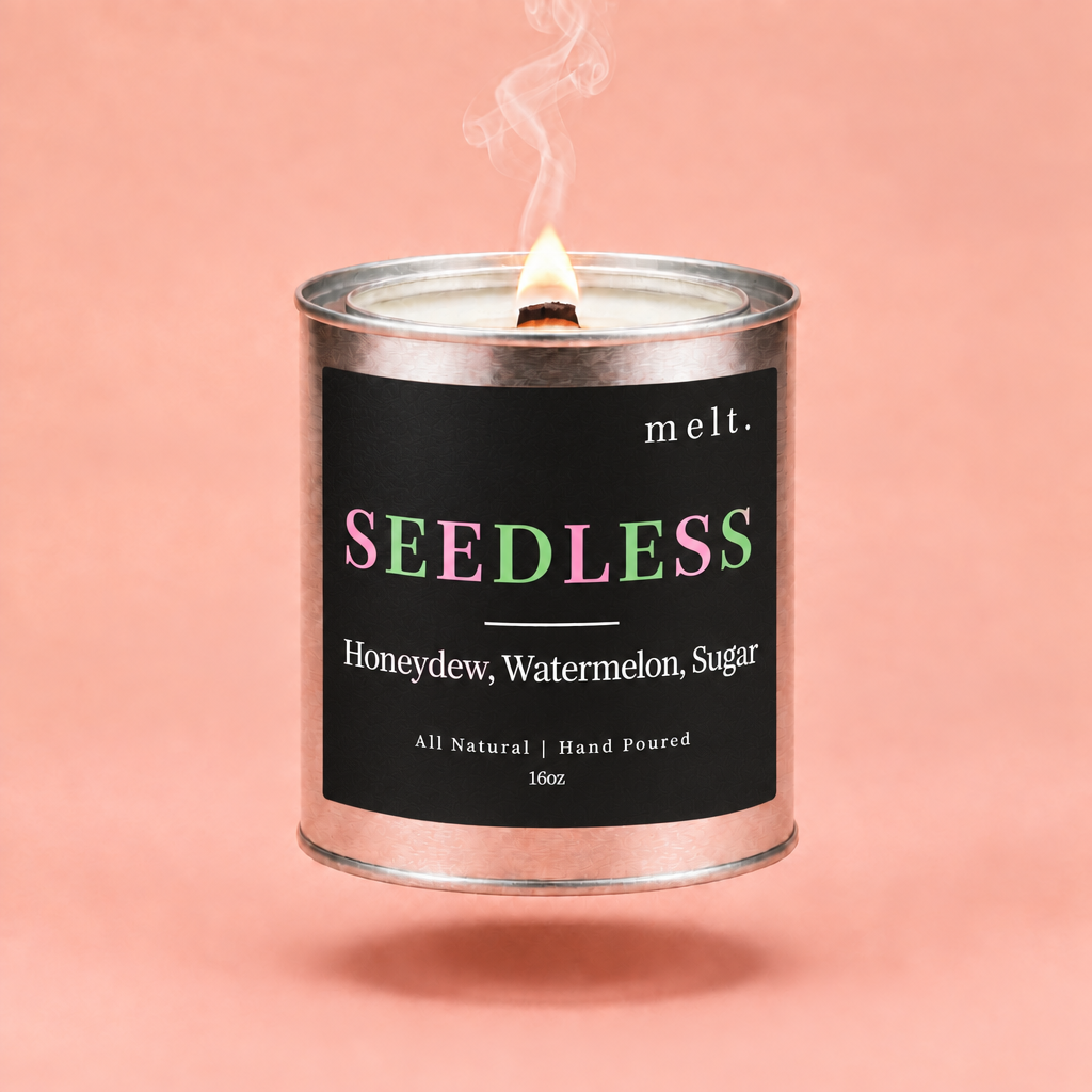 melt. seedless candle floating with lit wooden wick and a wisp of smoke on a pale peach coral background