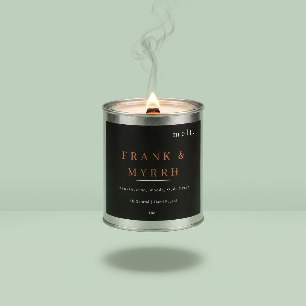 melt. frank & myrrh candle floating with lit wooden wick and a wisp of smoke on a pale mint green background